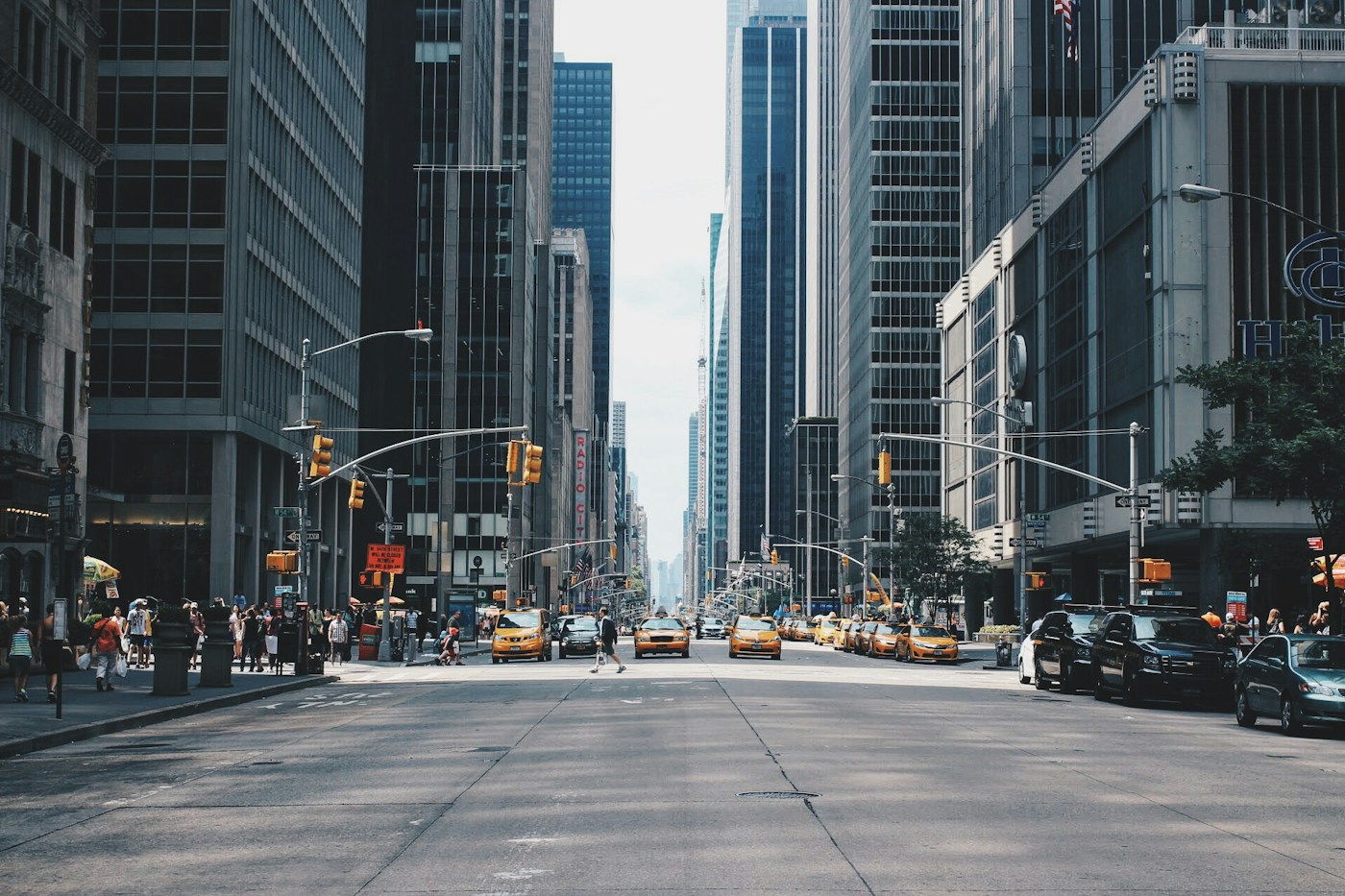 Busy urban avenue with public transport and pedestrians